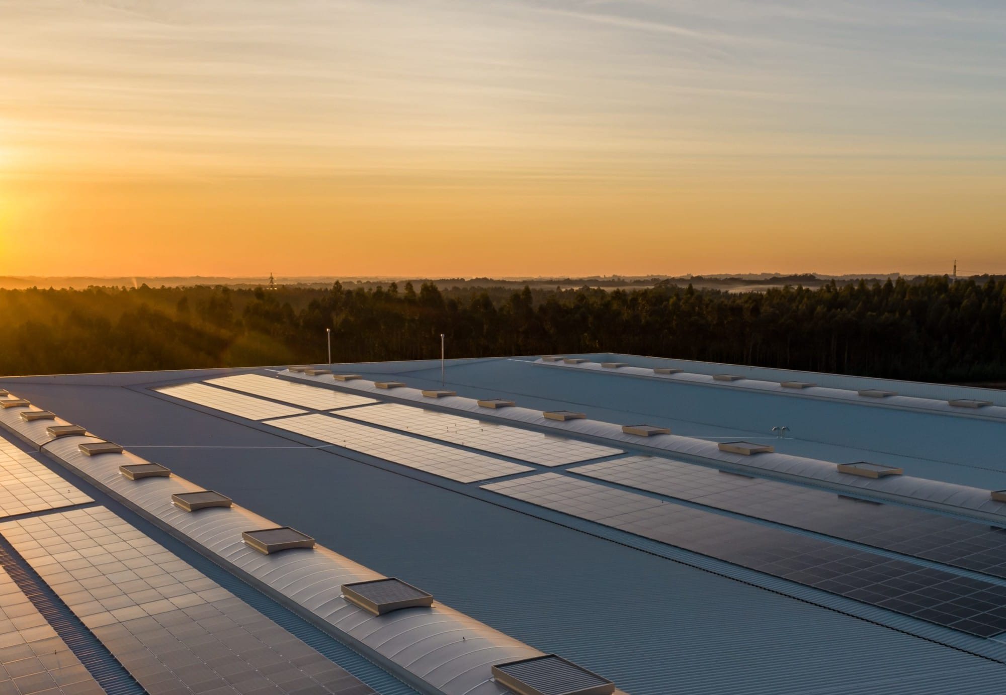 Roof-mounted solar panels at sunset
